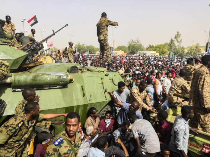 Sudanese soldiers and demonstrators face off during the 2019 coup outside army headquarters in the Sudanese capital Khartoum. Photo: Agence France-Presse